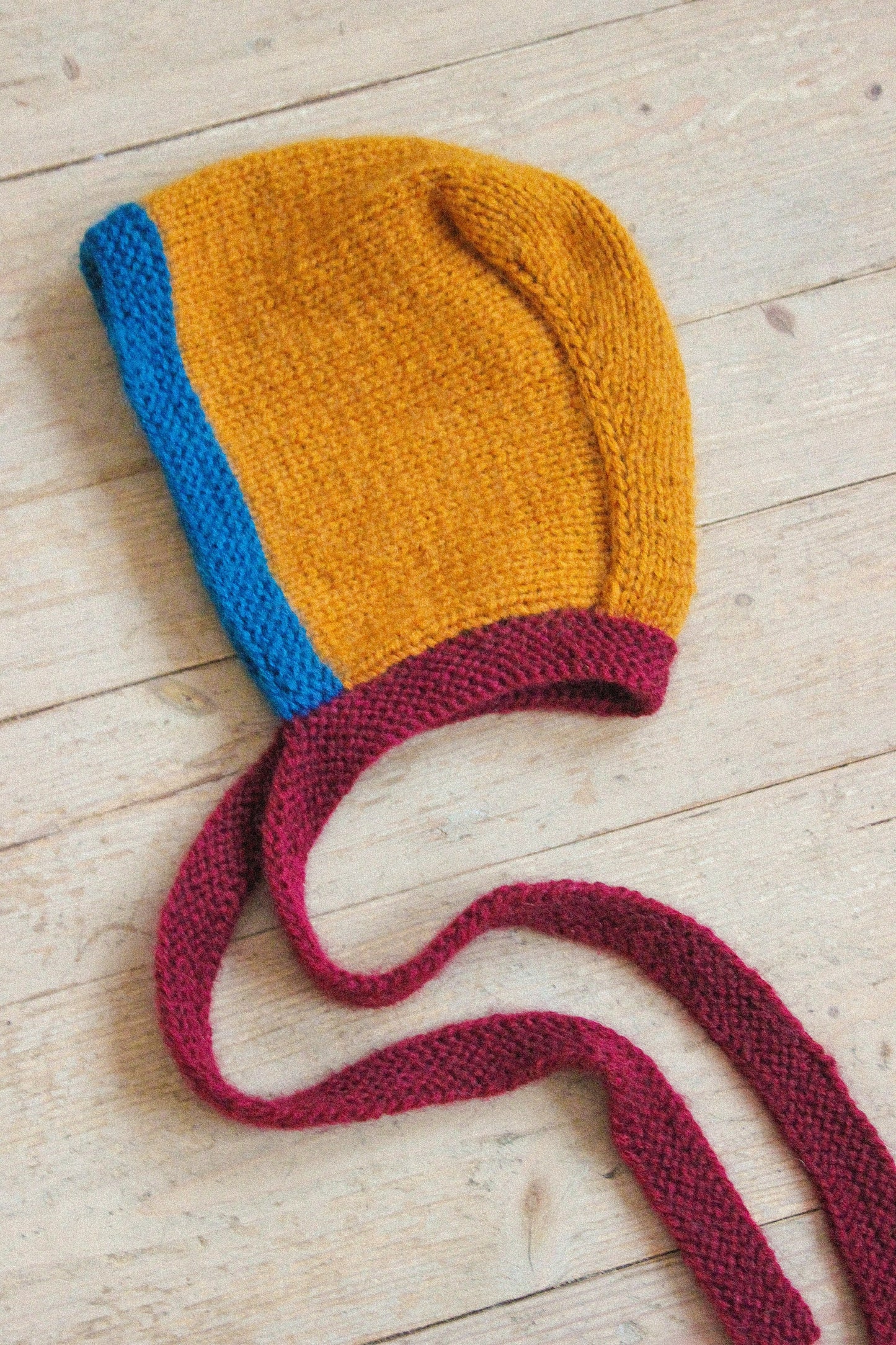 Hand-knitted Adult Bow Tie Bonnet hat in dull multicolor