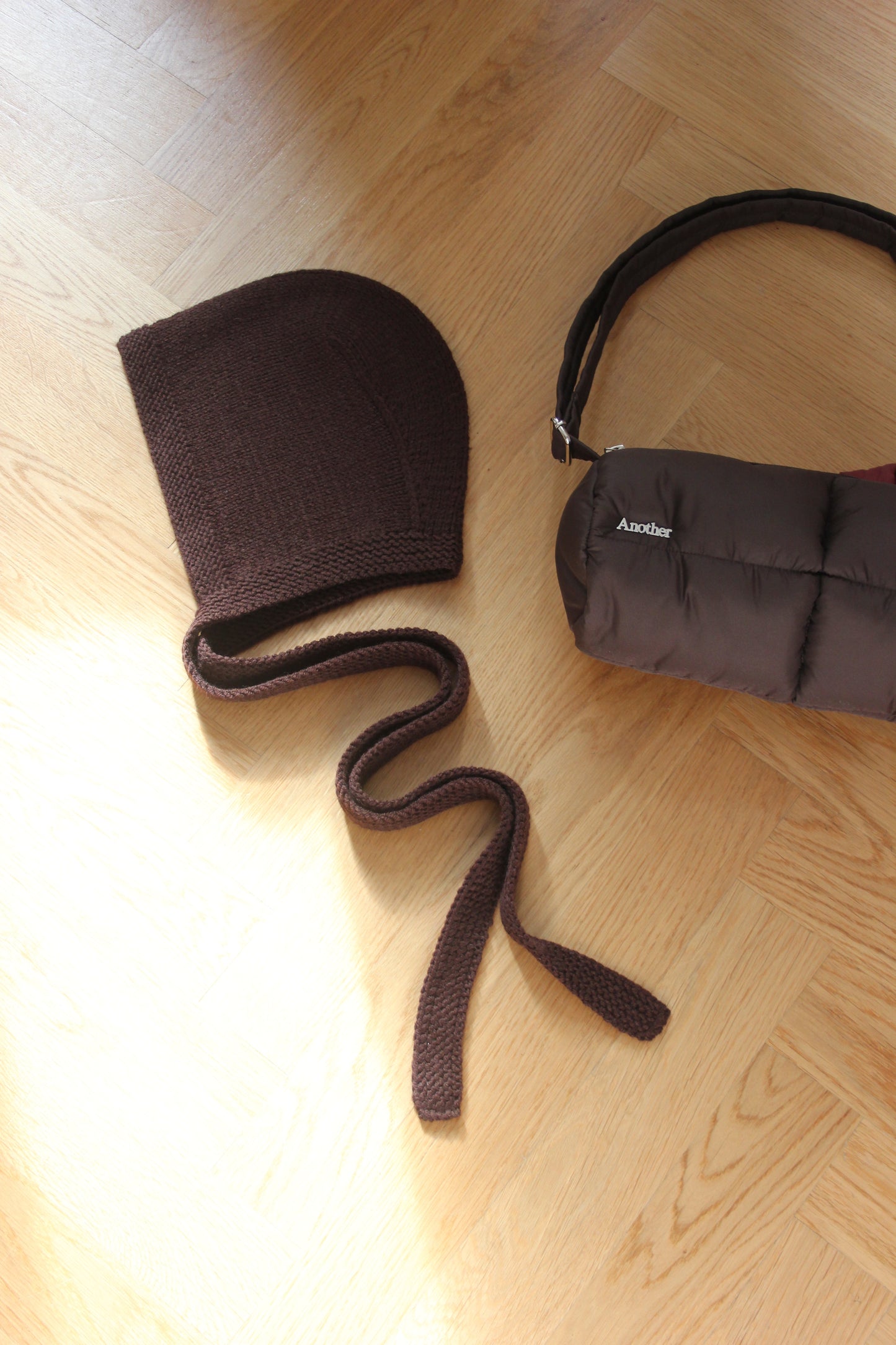 Pillow Puffer Cylinder bag in brown