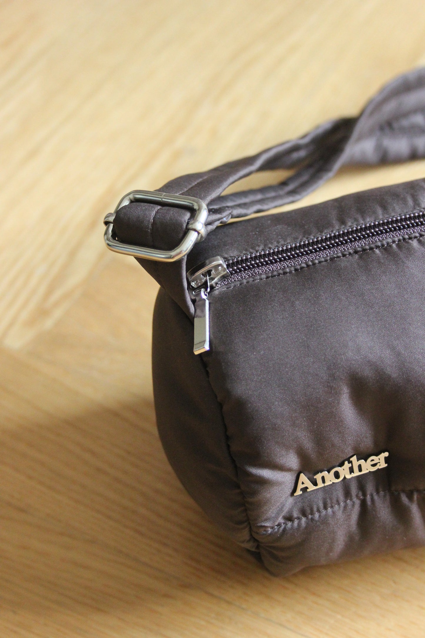 Pillow Puffer Cylinder bag in brown