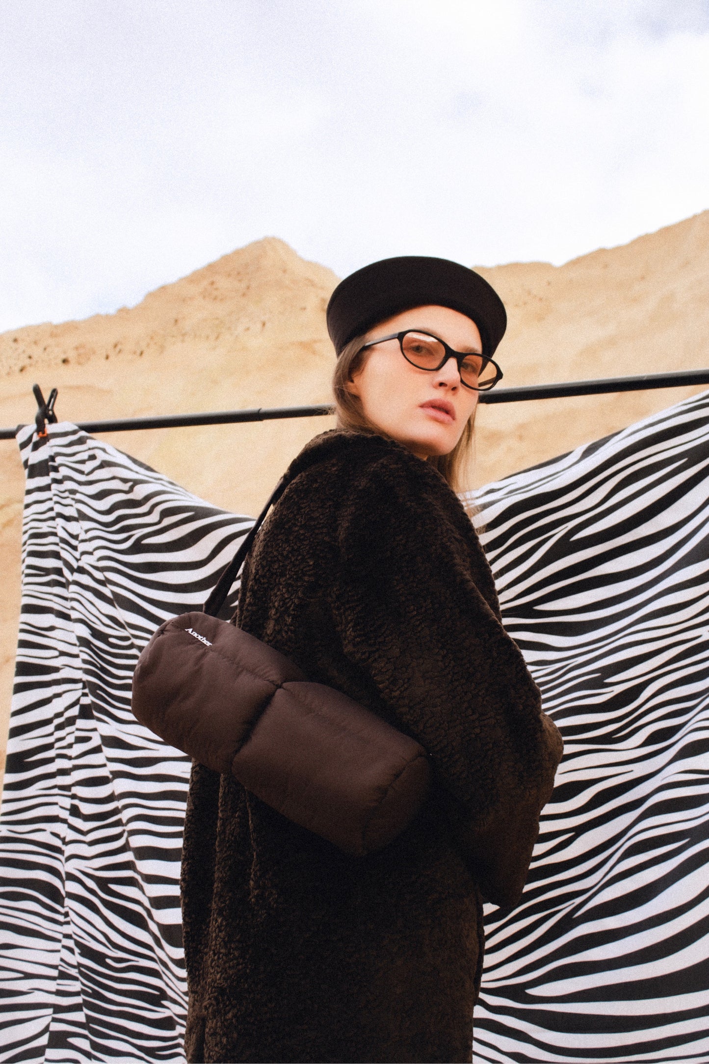 Pillow Puffer Cylinder bag in brown