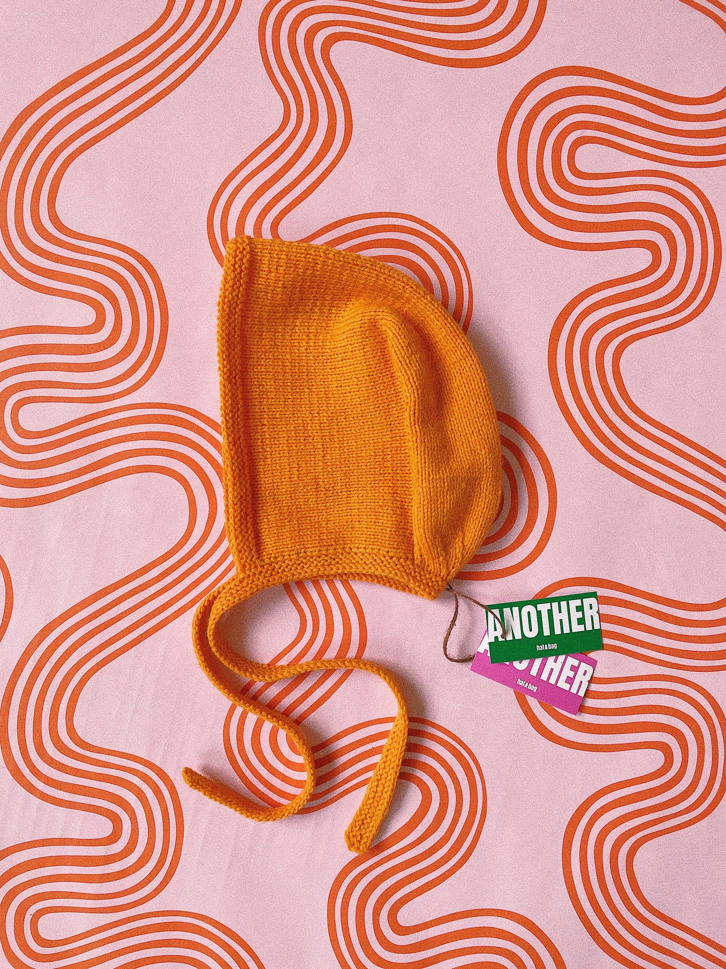 Hand-knitted Adult Bow Tie Bonnet hat in mandarin orange